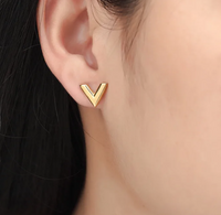 18K gold plated V earrings worn close up Kuwait Jewelique
